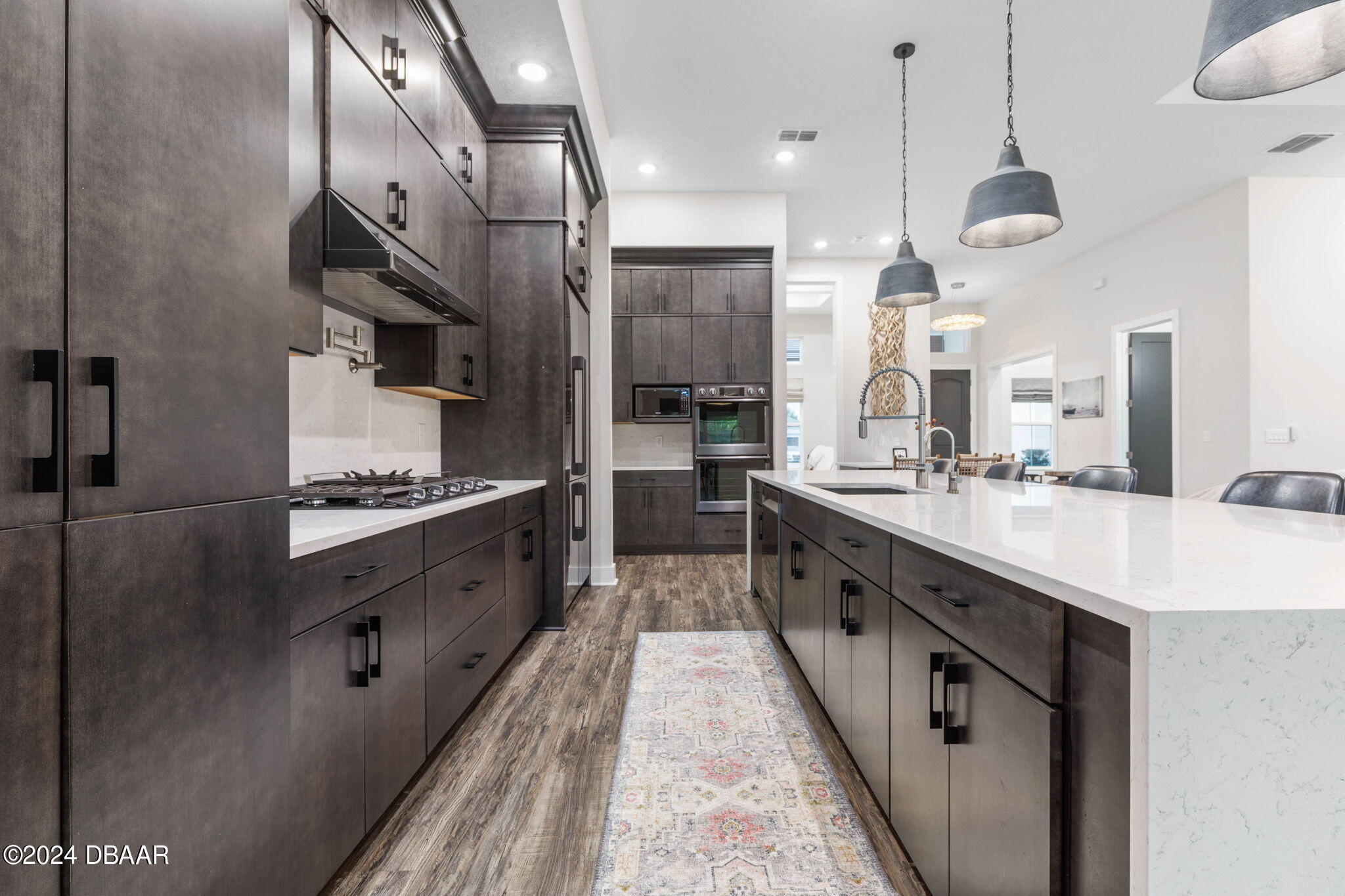 1405 Lilly Anne Circle Ormond Beach, FL 32174 - Photo 11 of 76 a large kitchen with stainless steel appliances kitchen island a large counter top space a sink and cabinets