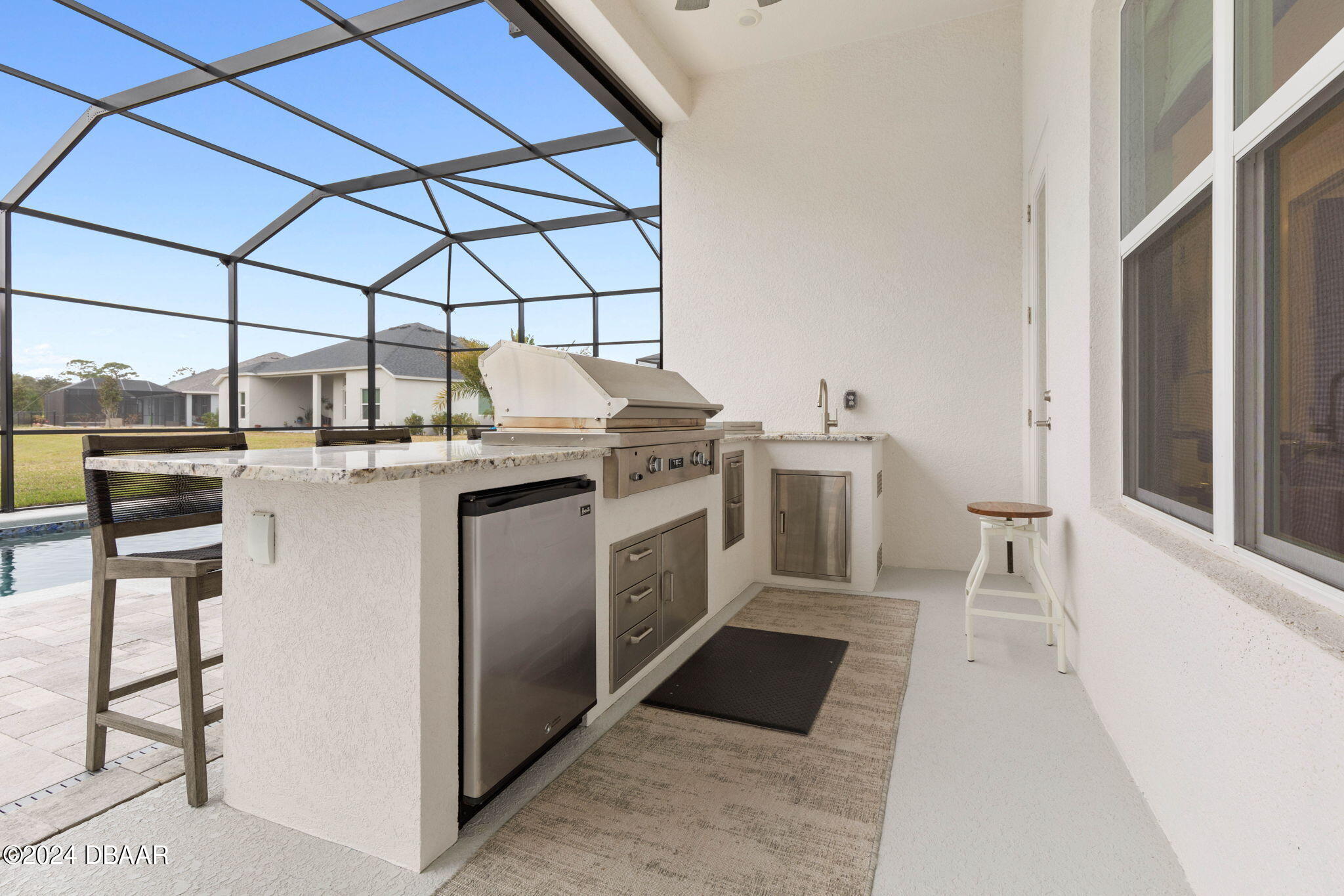 1405 Lilly Anne Circle Ormond Beach, FL 32174 - Photo 31 of 76 a kitchen with stainless steel appliances granite countertop a stove and a white cabinets