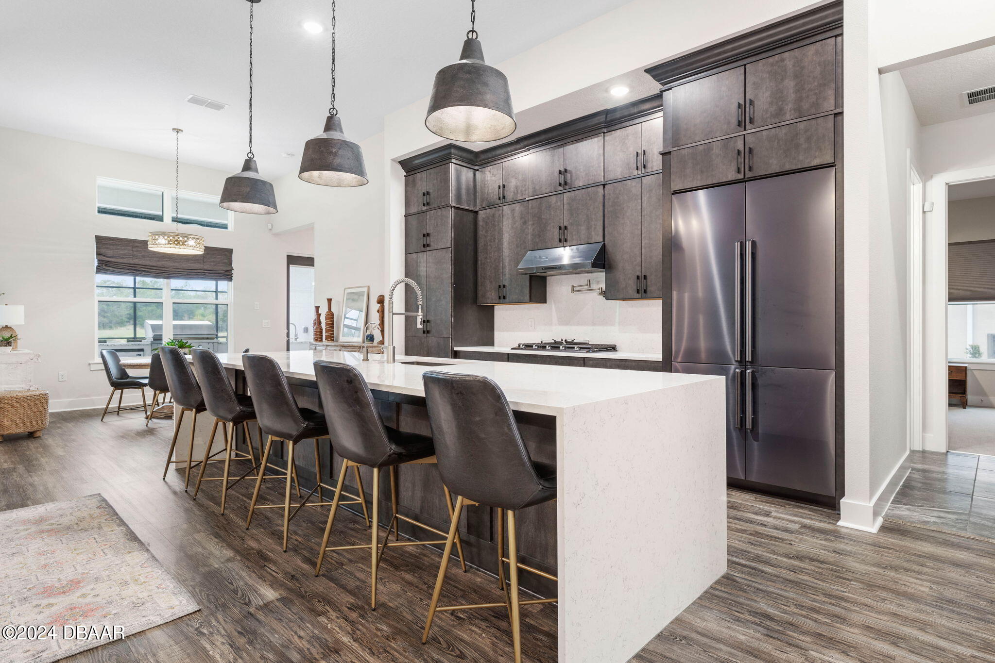 1405 Lilly Anne Circle Ormond Beach, FL 32174 - Photo 5 of 76 a kitchen with stainless steel appliances kitchen island granite countertop a refrigerator a stove a kitchen island with a dining table and chairs