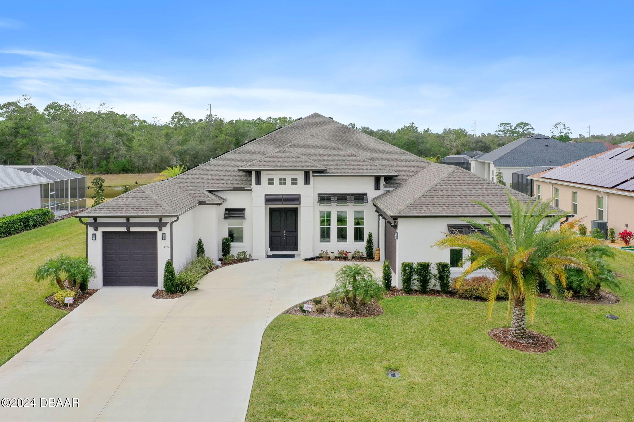 1405 Lilly Anne Circle Ormond Beach, FL 32174 - Photo 56 of 76 a front view of a house with a garden and plants