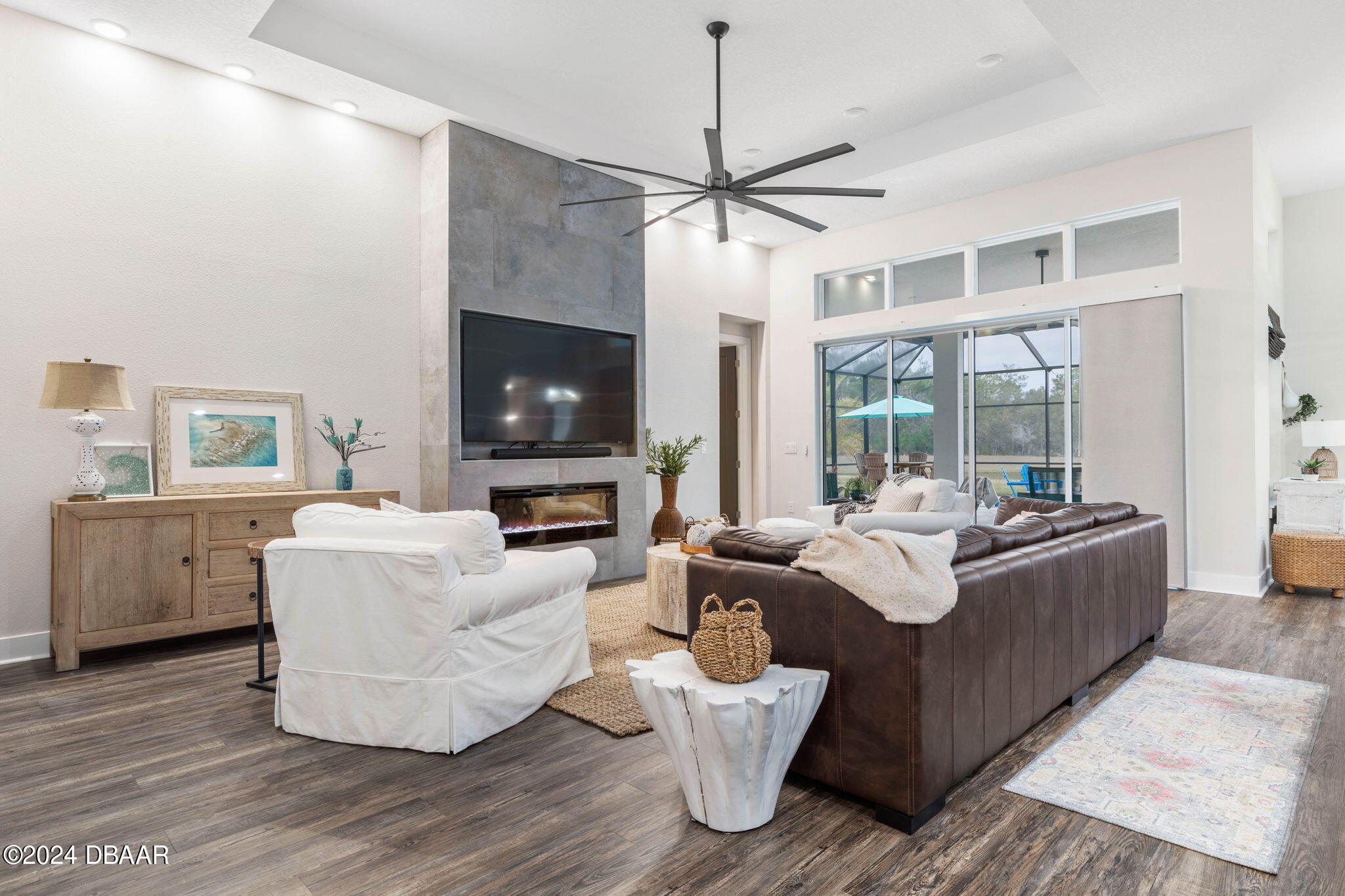 1405 Lilly Anne Circle Ormond Beach, FL 32174 - Photo 6 of 76 a living room with furniture a flat screen tv and a fireplace