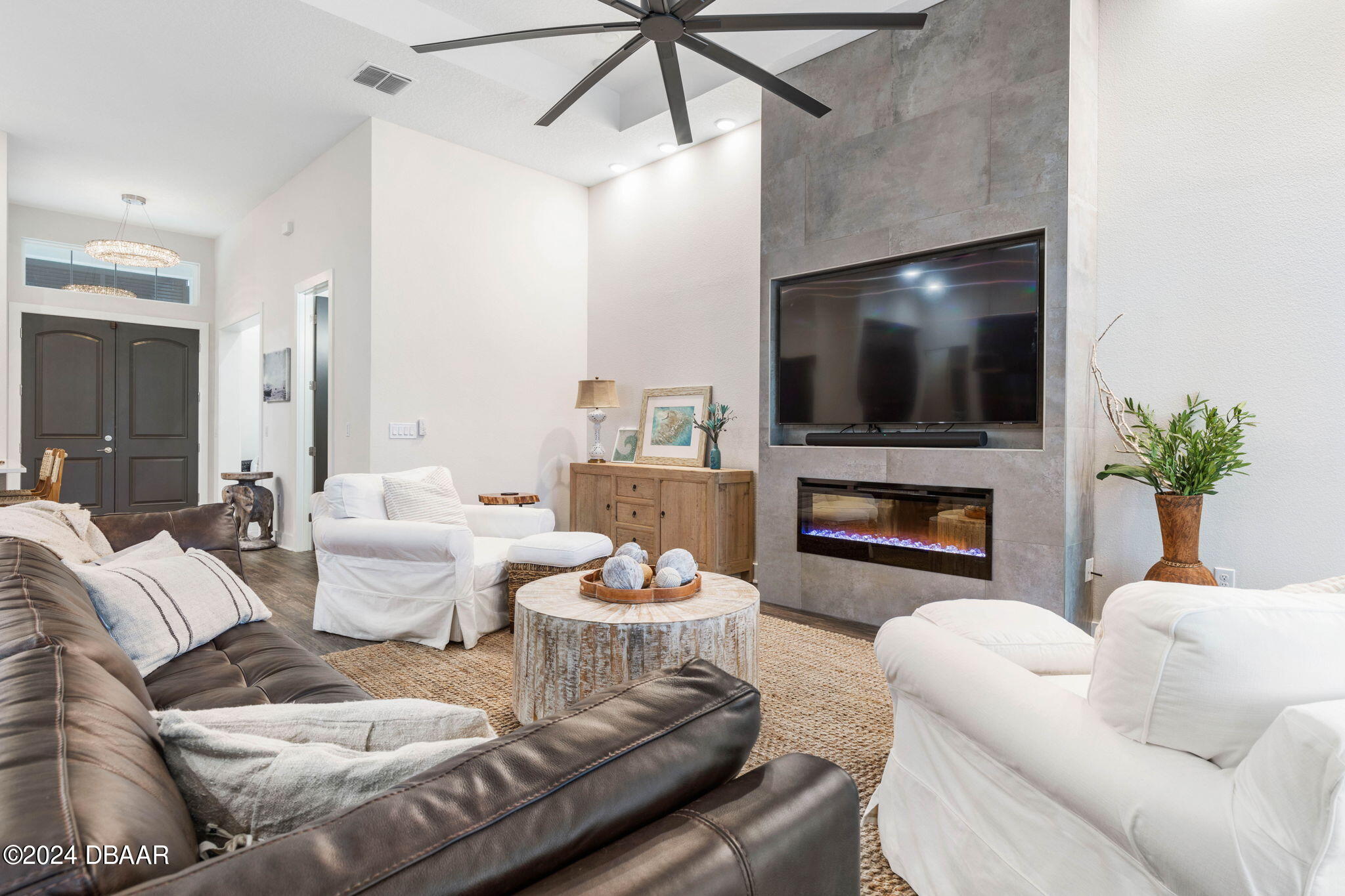 1405 Lilly Anne Circle Ormond Beach, FL 32174 - Photo 9 of 76 a living room with furniture a flat screen tv and a fireplace