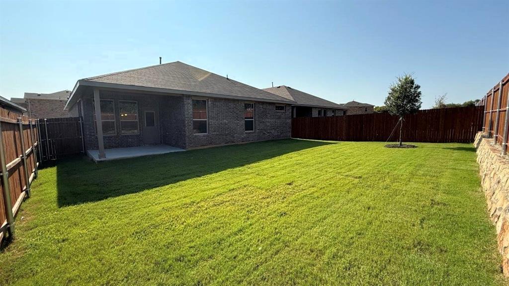 107 Goodnight Court Cleburne, TX 76033 - Photo 35 of 36 a front view of a house with garden