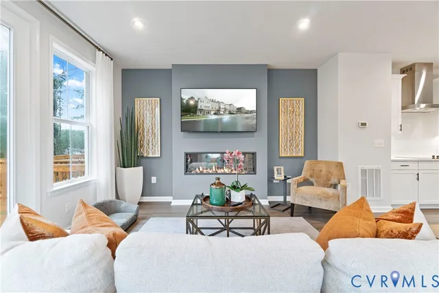 a living room with furniture a large window and a flat screen tv