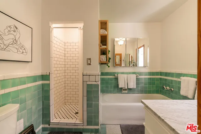 a bathroom with a sink a mirror and a shower