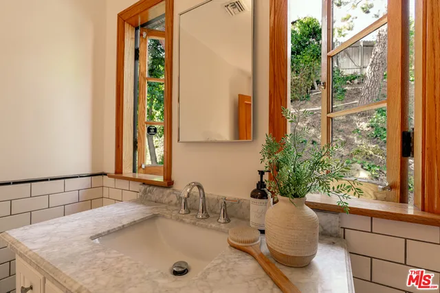 a bathroom with a shower and a sink