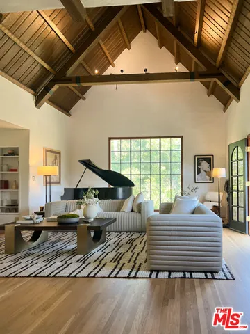 a view of swimming pool with furniture and city view