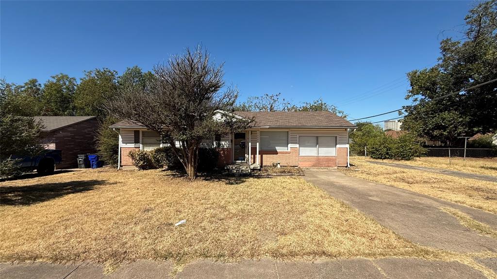 12225 Schroeder Road Dallas, TX 75243 - Photo 1 of 40 Single-story residence featuring a brick and siding exterior, a gabled roof, and a mature front yard tree