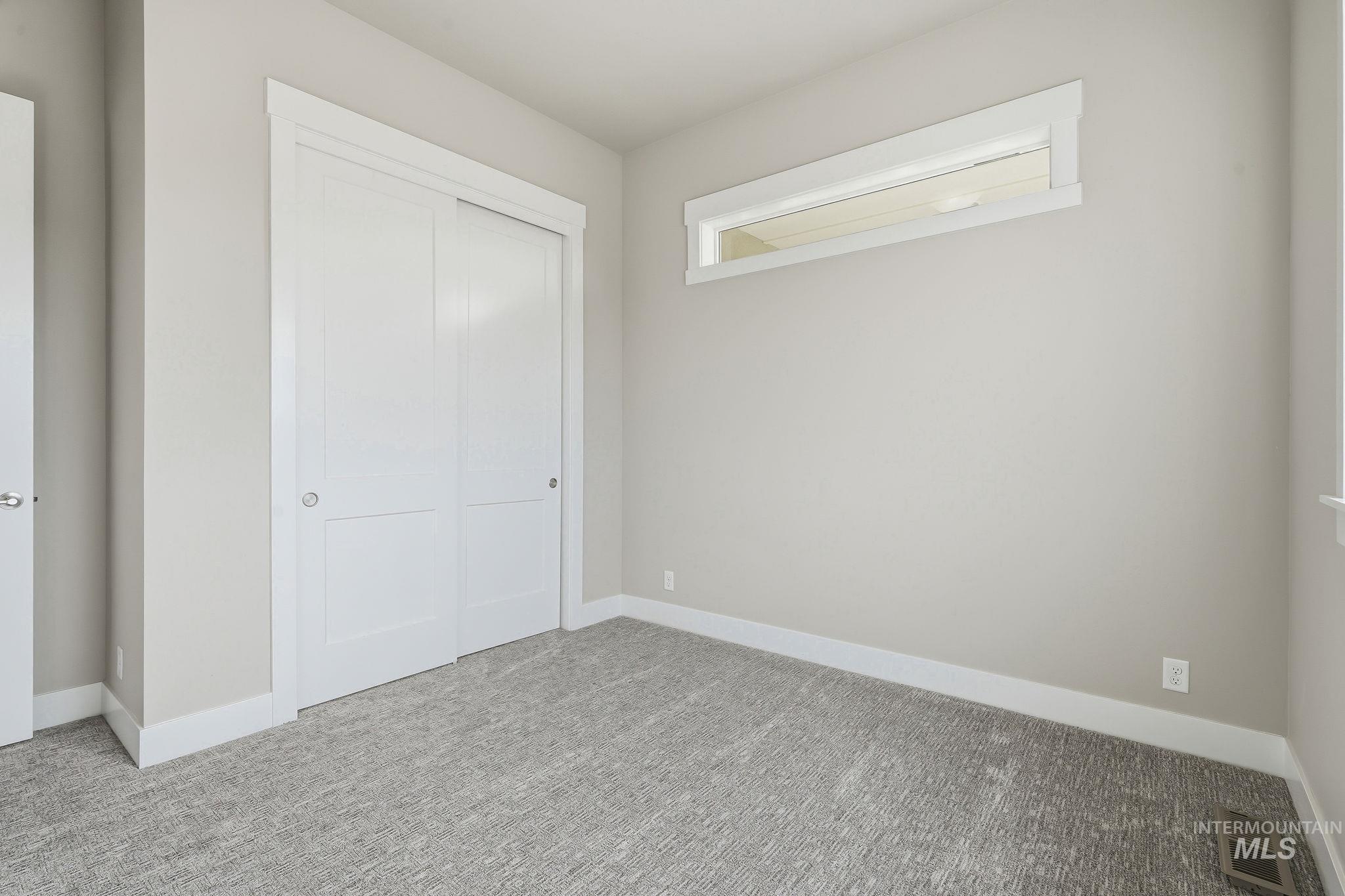 470 South Radiator Way Boise, ID 83716 - Photo 37 of 50 Room featuring neutral-toned walls, textured gray carpeting, and white baseboards