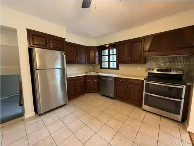 a kitchen with a refrigerator sink and cabinets