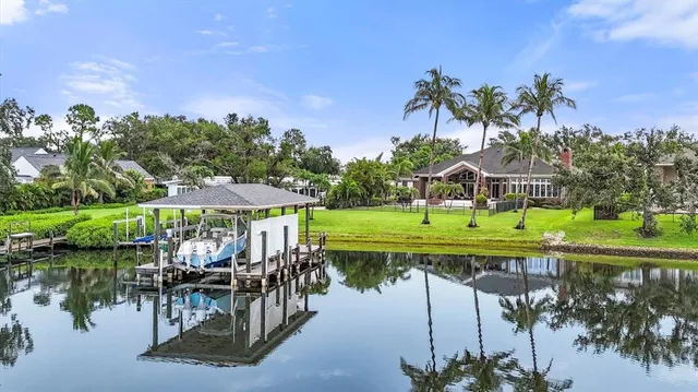 a front view of a house with a yard and trees