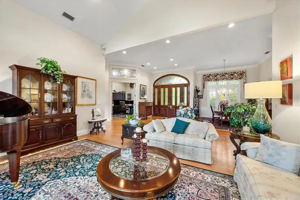 a living room with furniture windows and a flat screen tv