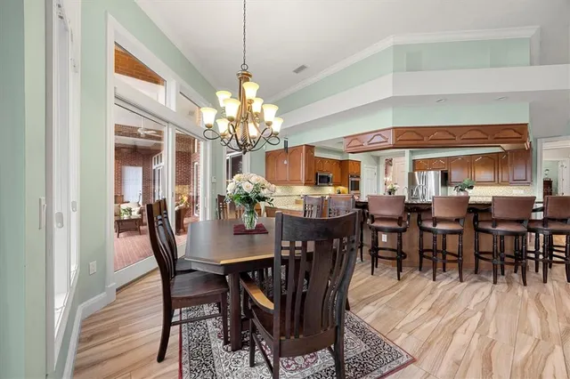 a bedroom with a bed dresser and refrigerator