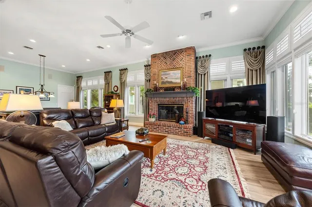 a living room with furniture windows and a flat screen tv