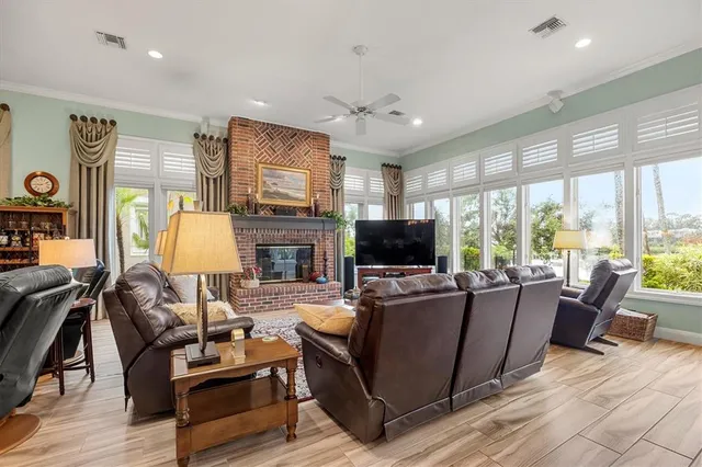 a living room with furniture a flat screen tv and a window