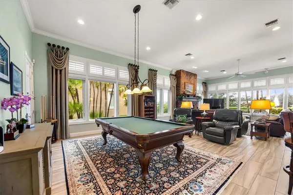 a view of a swimming pool with a garden and palm trees