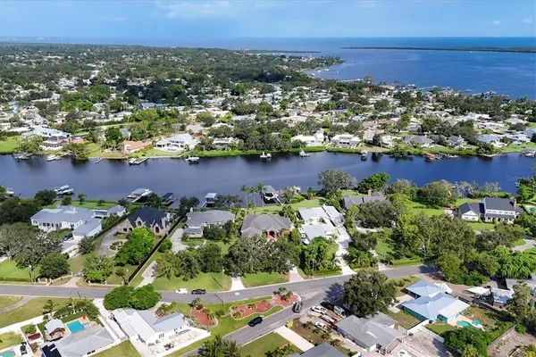an aerial view of house with yard and lake view