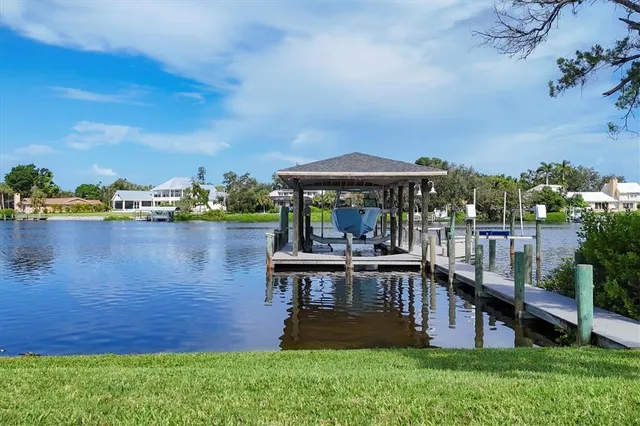 an aerial view of house with yard and lake view