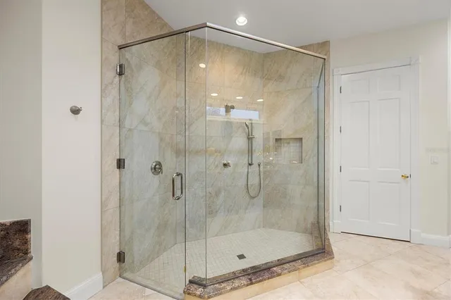 an aerial view of residential houses with outdoor space and trees