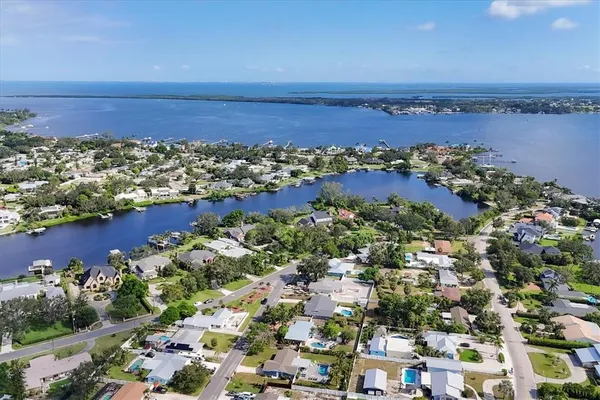 a living room with stainless steel appliances granite countertop furniture wooden floor and a large window