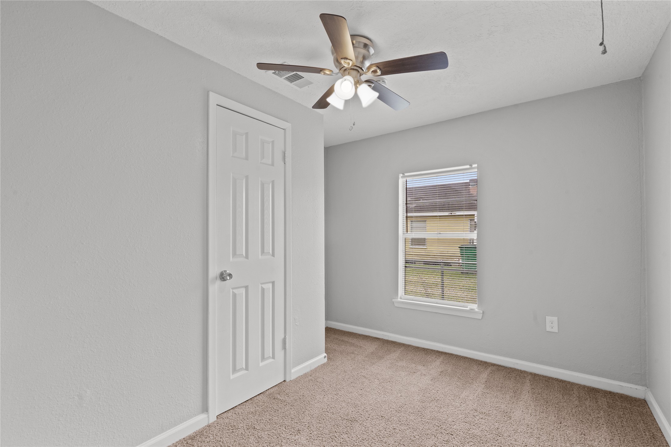 419 North Parrish Street Angleton, TX 77515 - Photo 11 of 25 an empty room with windows and fan