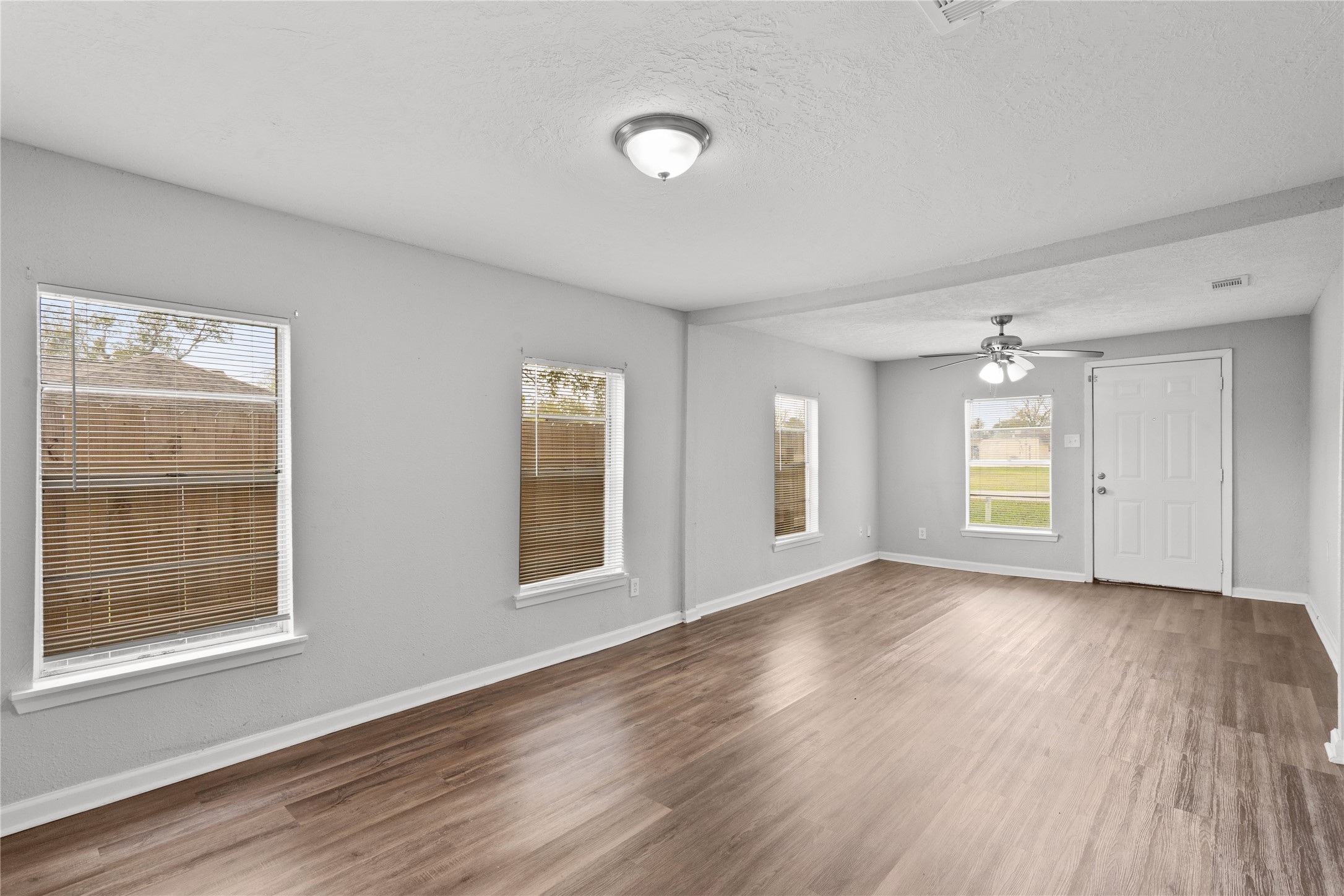 419 North Parrish Street Angleton, TX 77515 - Photo 15 of 25 a view of empty room with wooden floor and fan