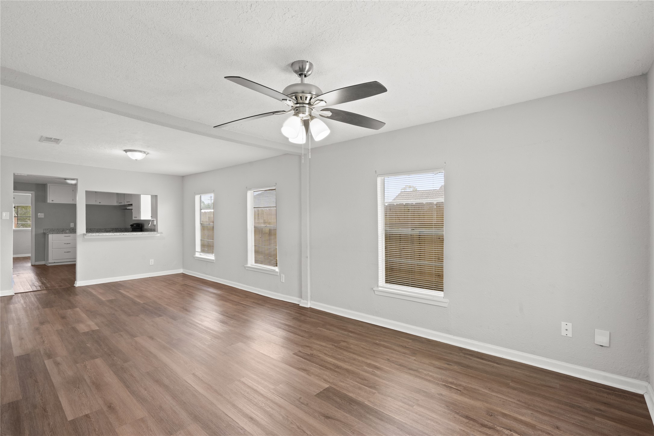 419 North Parrish Street Angleton, TX 77515 - Photo 16 of 25 a view of an empty room with window and wooden floor