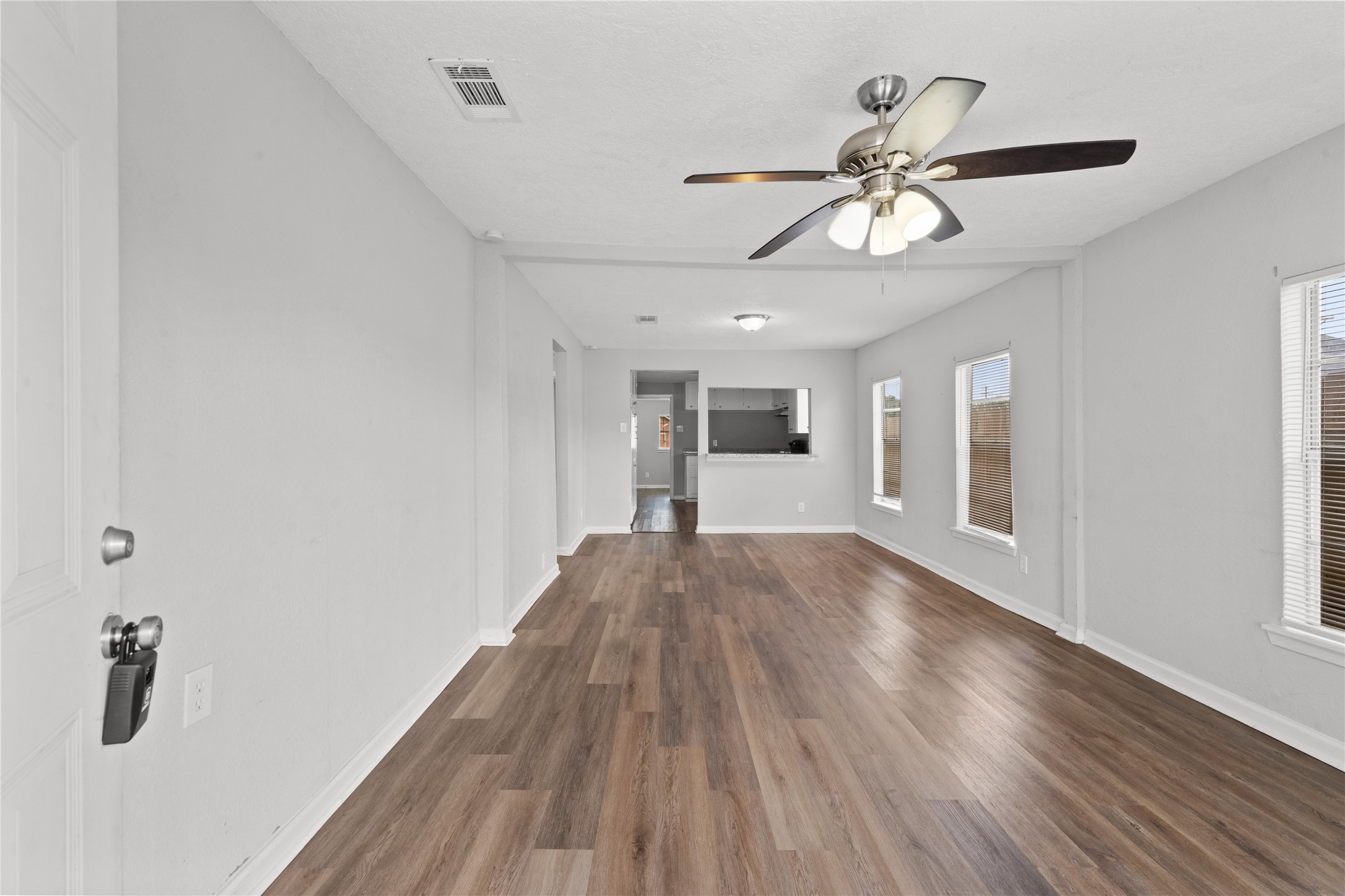419 North Parrish Street Angleton, TX 77515 - Photo 20 of 25 a view of empty room with wooden floor and ceiling fan