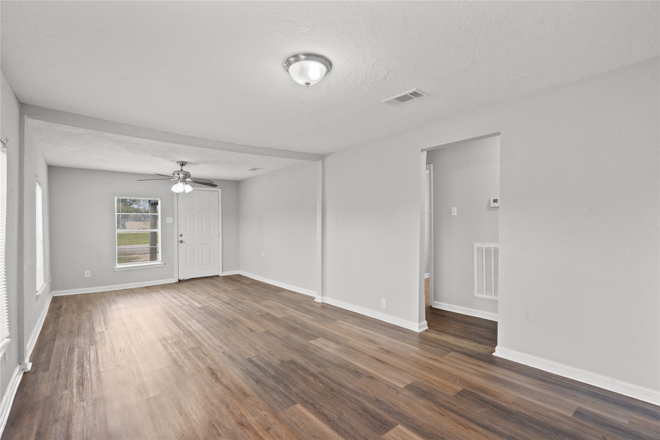419 North Parrish Street Angleton, TX 77515 - Photo 5 of 25 a view of empty room with wooden floor and window
