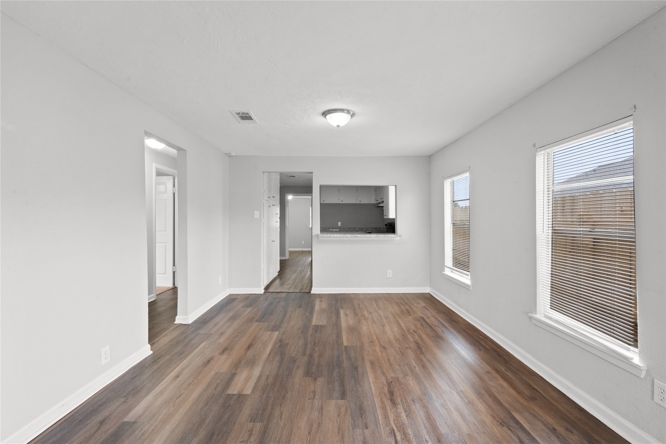 419 North Parrish Street Angleton, TX 77515 - Photo 9 of 25 a view of a big room with wooden floor and windows