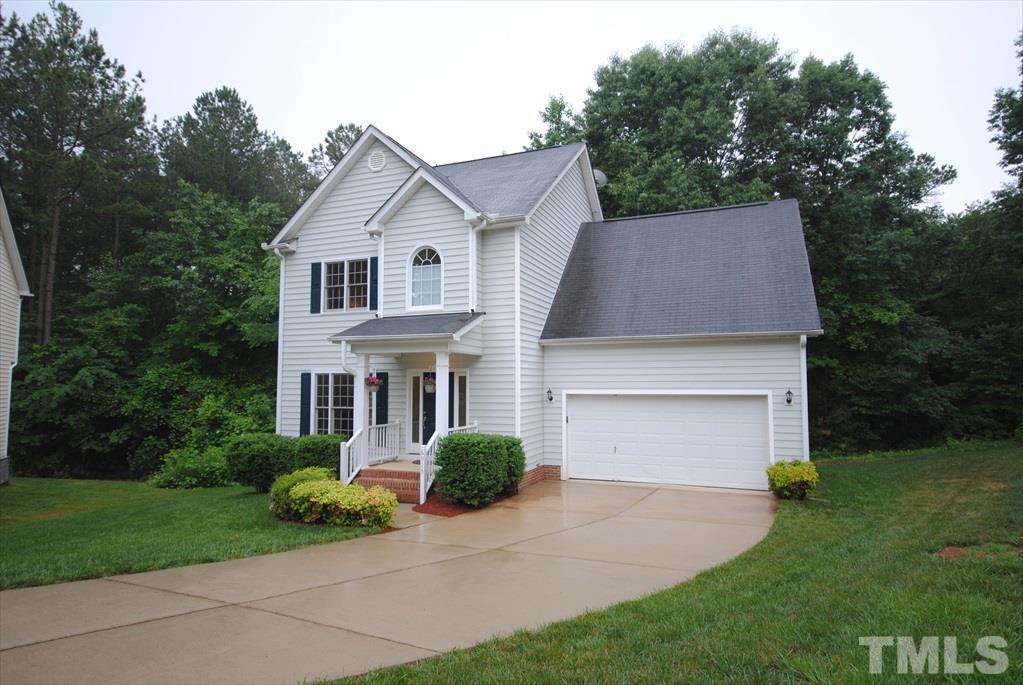 6915 Brigmore Court Raleigh, NC 27617 - Photo 2 of 25 a front view of a house with a yard and garage