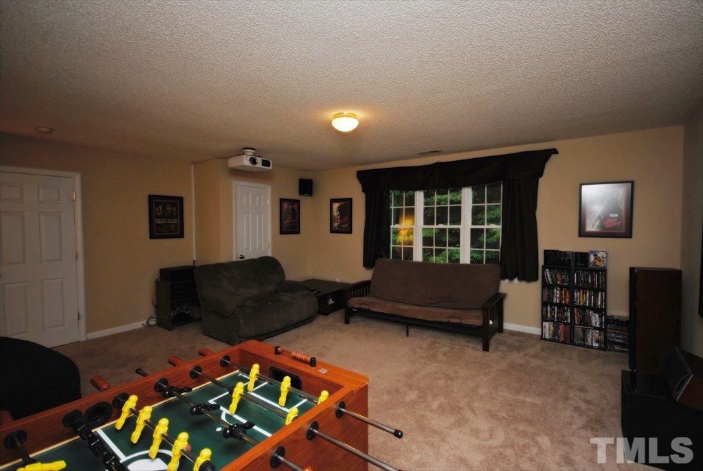 6915 Brigmore Court Raleigh, NC 27617 - Photo 15 of 25 a living room with furniture and a window