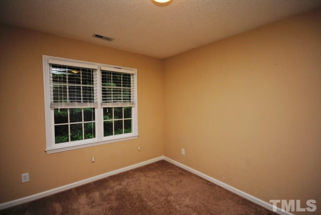 6915 Brigmore Court Raleigh, NC 27617 - Photo 17 of 25 a view of empty room with windows