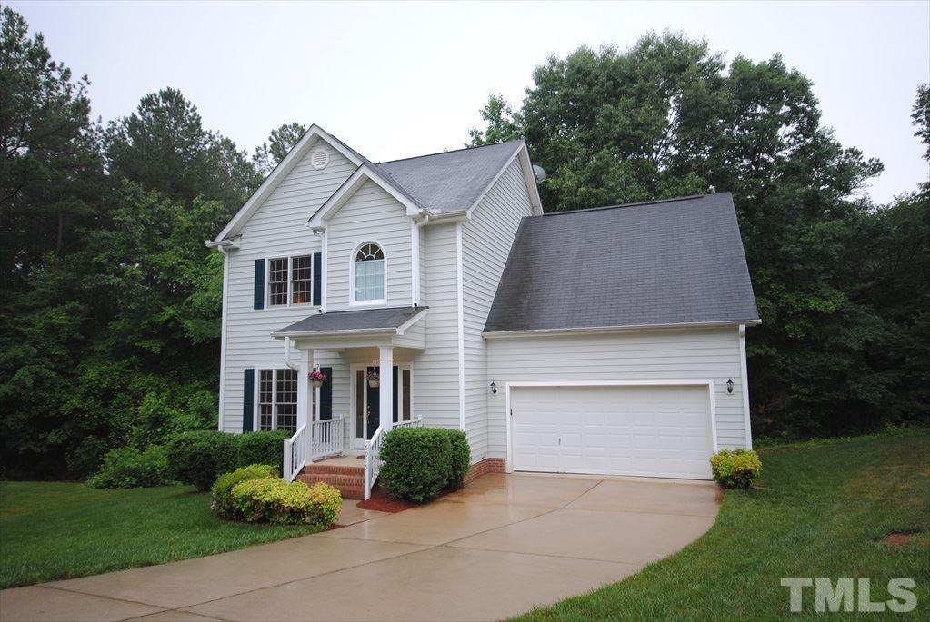 6915 Brigmore Court Raleigh, NC 27617 - Photo 3 of 25 a front view of a house with a garden and plants