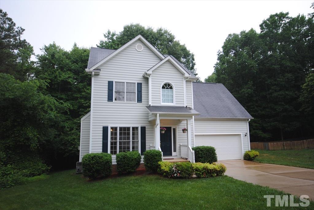 6915 Brigmore Court Raleigh, NC 27617 - Photo 4 of 25 a front view of a house with a yard and green space