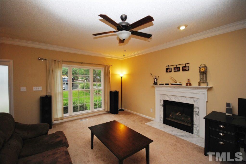 6915 Brigmore Court Raleigh, NC 27617 - Photo 6 of 25 a living room with furniture and a fireplace