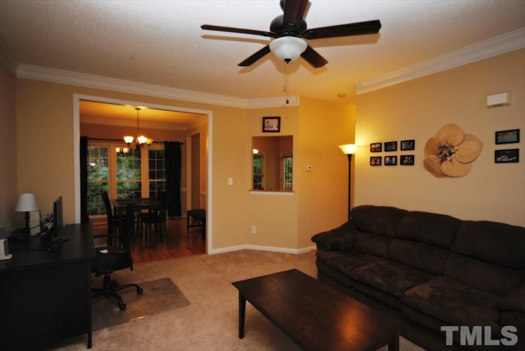 6915 Brigmore Court Raleigh, NC 27617 - Photo 8 of 25 a living room with furniture and a ceiling fan