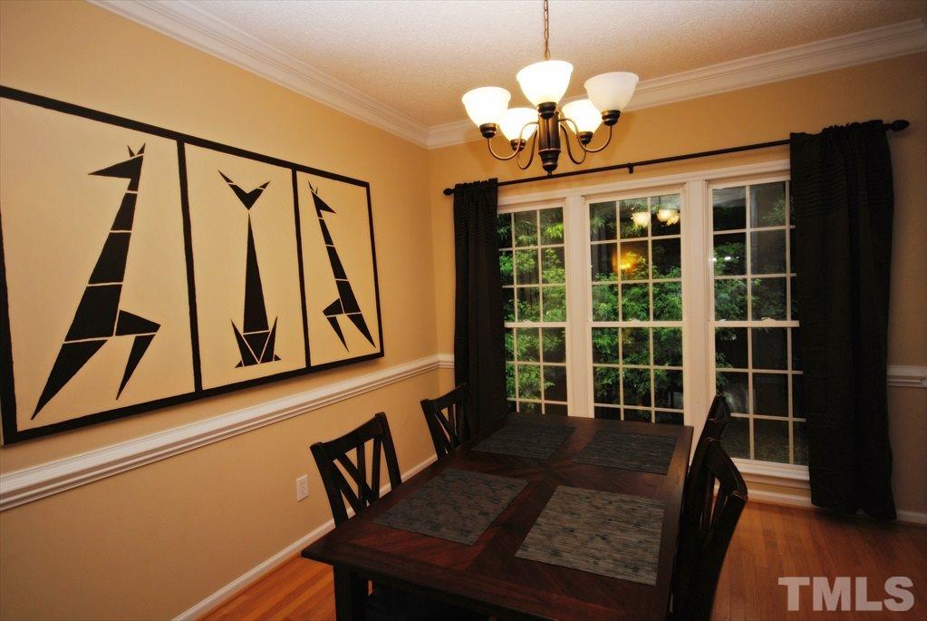 6915 Brigmore Court Raleigh, NC 27617 - Photo 9 of 25 a view of a dining room with furniture and a chandelier