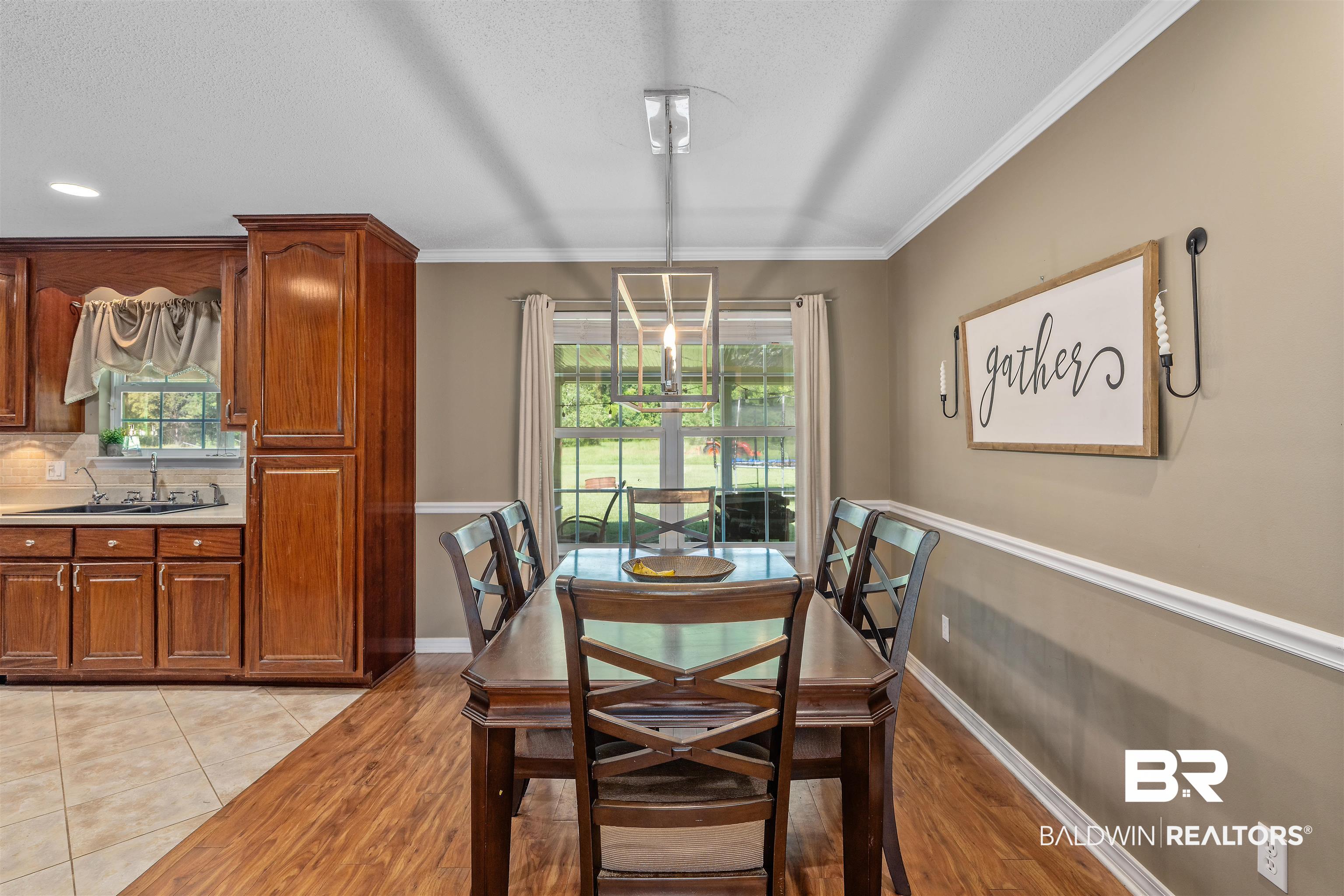 34711 Pond Road Stapleton, AL 36578 - Photo 10 of 38 Dining area featuring light wood-style floors, ornamental molding, and a textured ceiling