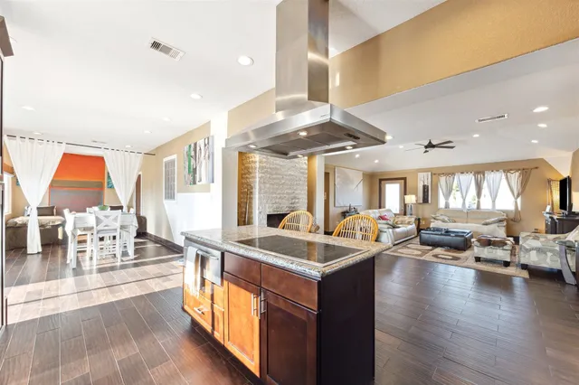 a very nice looking living room with kitchen and a large window