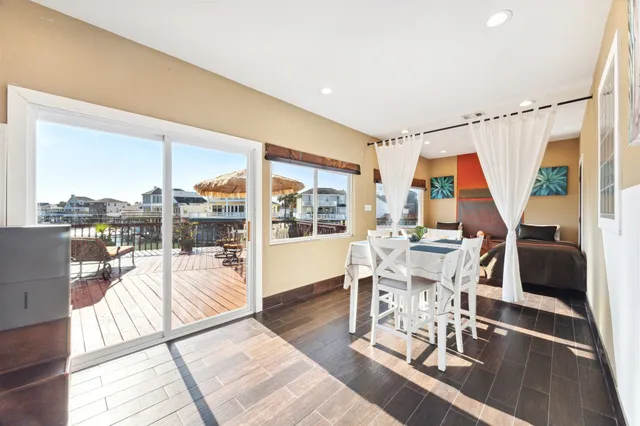 a dining room with wooden floor and a table
