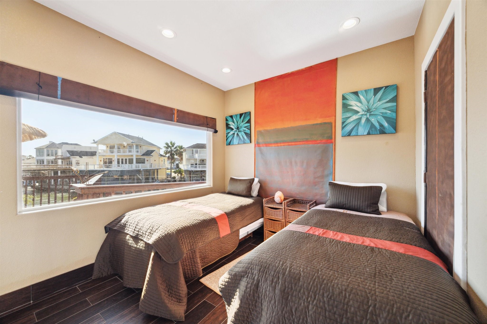 410 Isles End Road Tiki Island, TX 77554 - Photo 9 of 13 a bedroom with two large bed and a large window