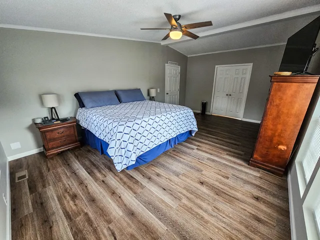 a bedroom with a bed and a flat screen tv