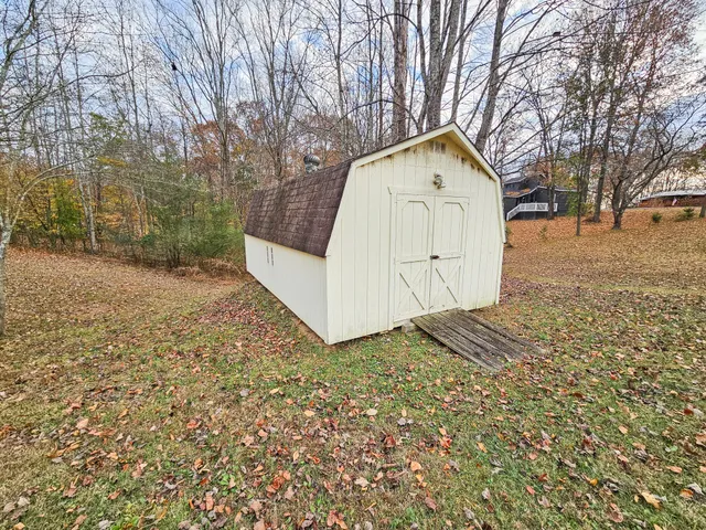 a view of a backyard with large trees