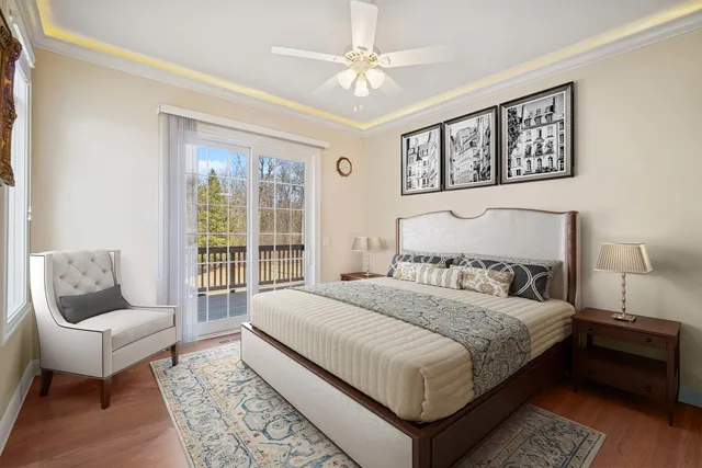 a bedroom with a large bed couch and a window