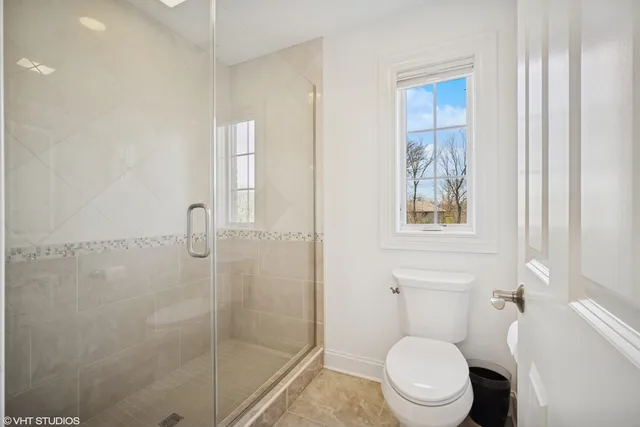 a white toilet sitting next to a bathroom sink