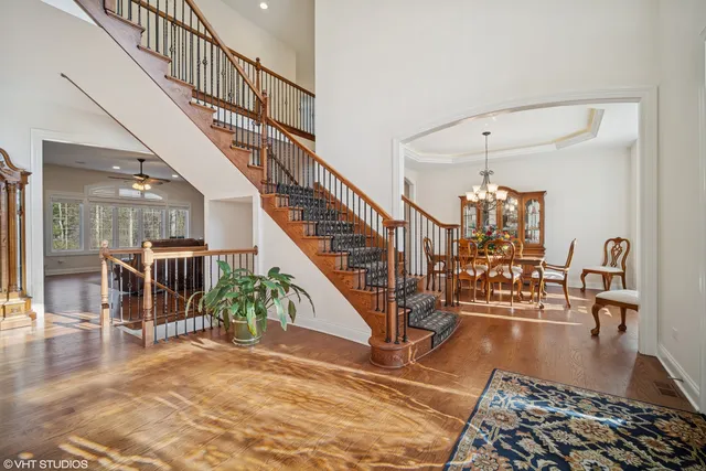 a view of entryway and hall with wooden floor