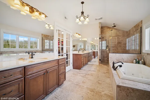 a bathroom with a tub sink and mirror