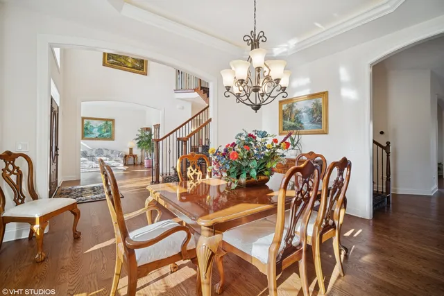 a view of a dining room with furniture and chandelier