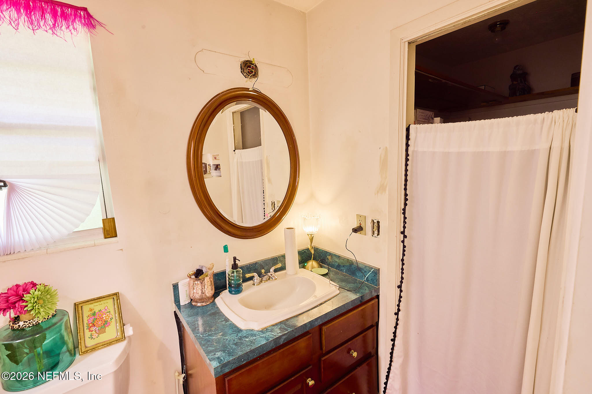 8965 San Rae Road Jacksonville, FL 32257 - Photo 20 of 46 a bathroom with a sink and a mirror